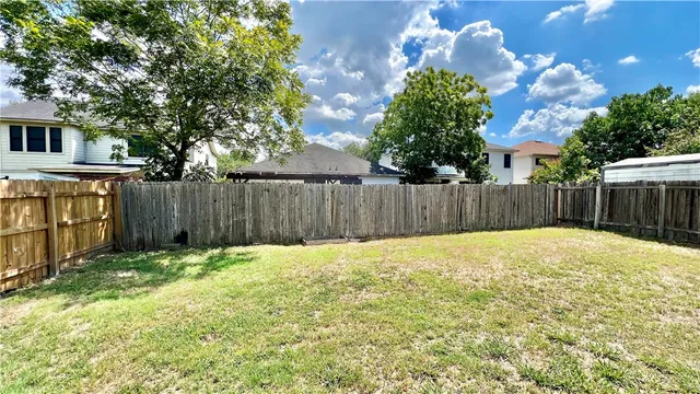 a bathroom with a small yard and wooden fence