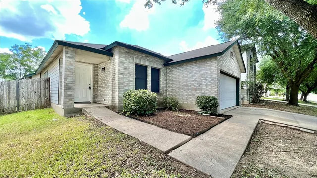 a backyard of a house with plants and trees