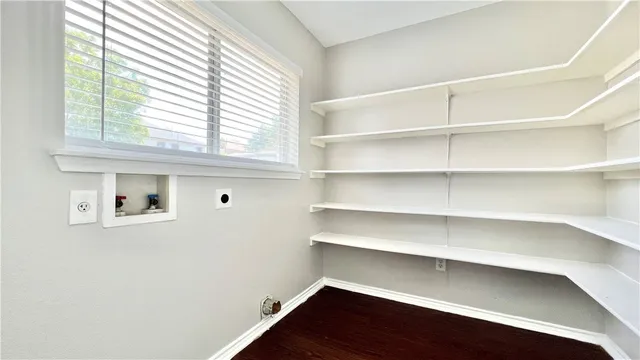 a view of a room with shelf and a window
