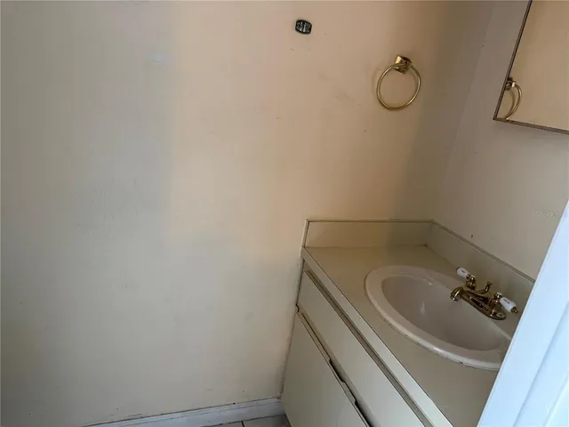 a bathroom with a sink and cabinets