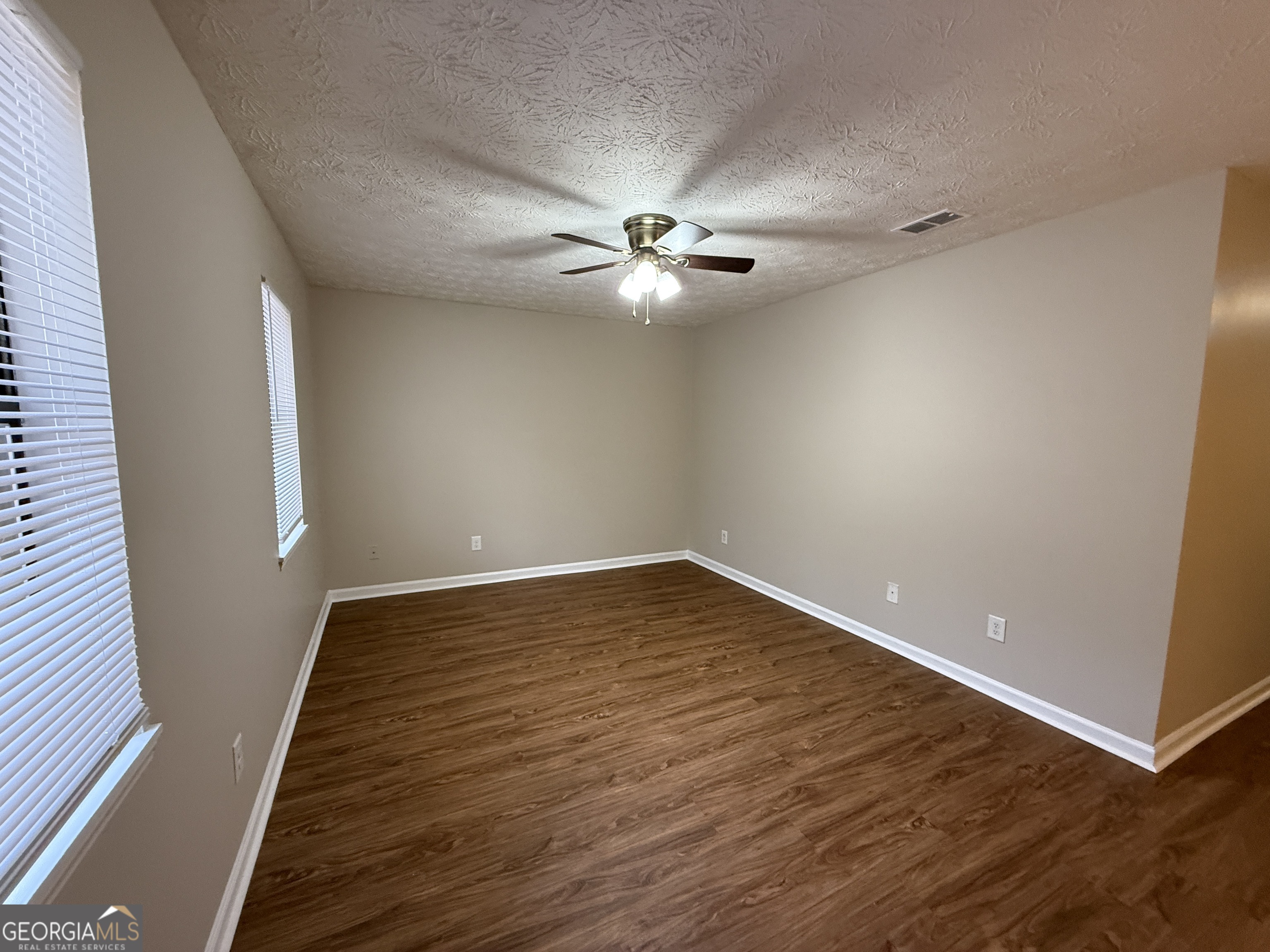 110 St Andrews Court, Unit 110 Athens, GA 30605 - Photo 2 of 13 wooden floor in an empty room with a window
