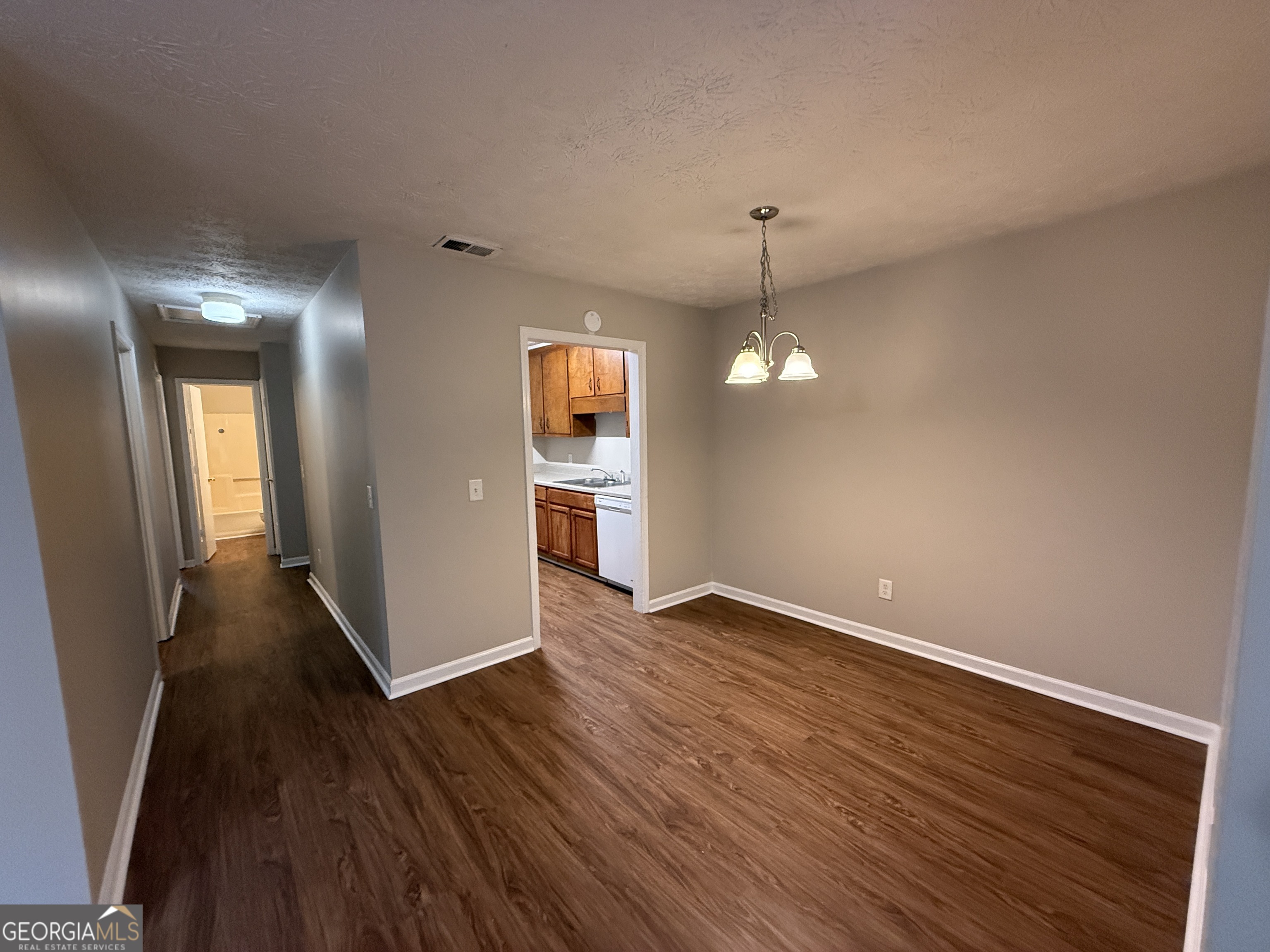 110 St Andrews Court, Unit 110 Athens, GA 30605 - Photo 4 of 13 an empty room with wooden floor and windows