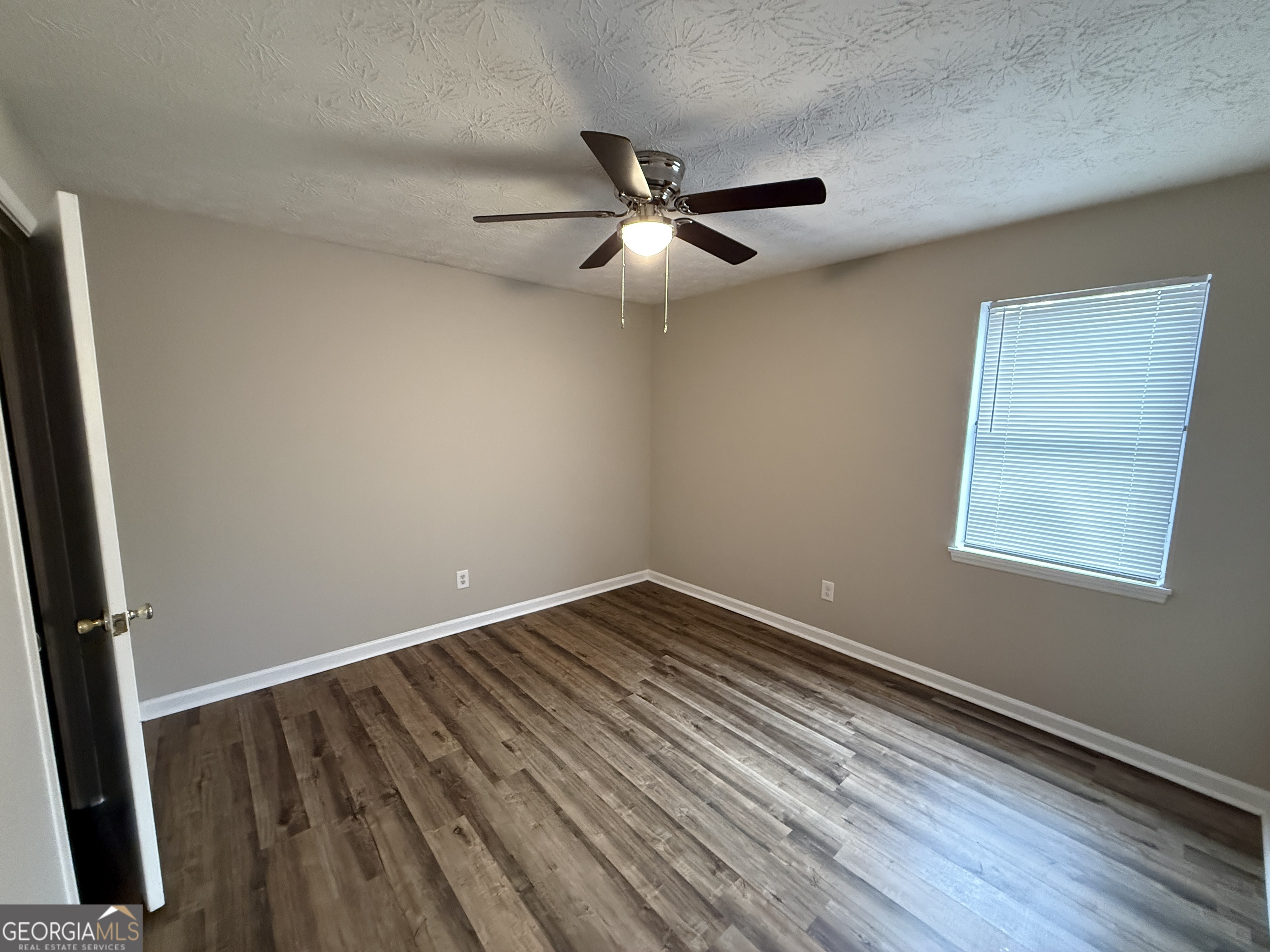 110 St Andrews Court, Unit 110 Athens, GA 30605 - Photo 6 of 13 wooden floor in an empty room with a window