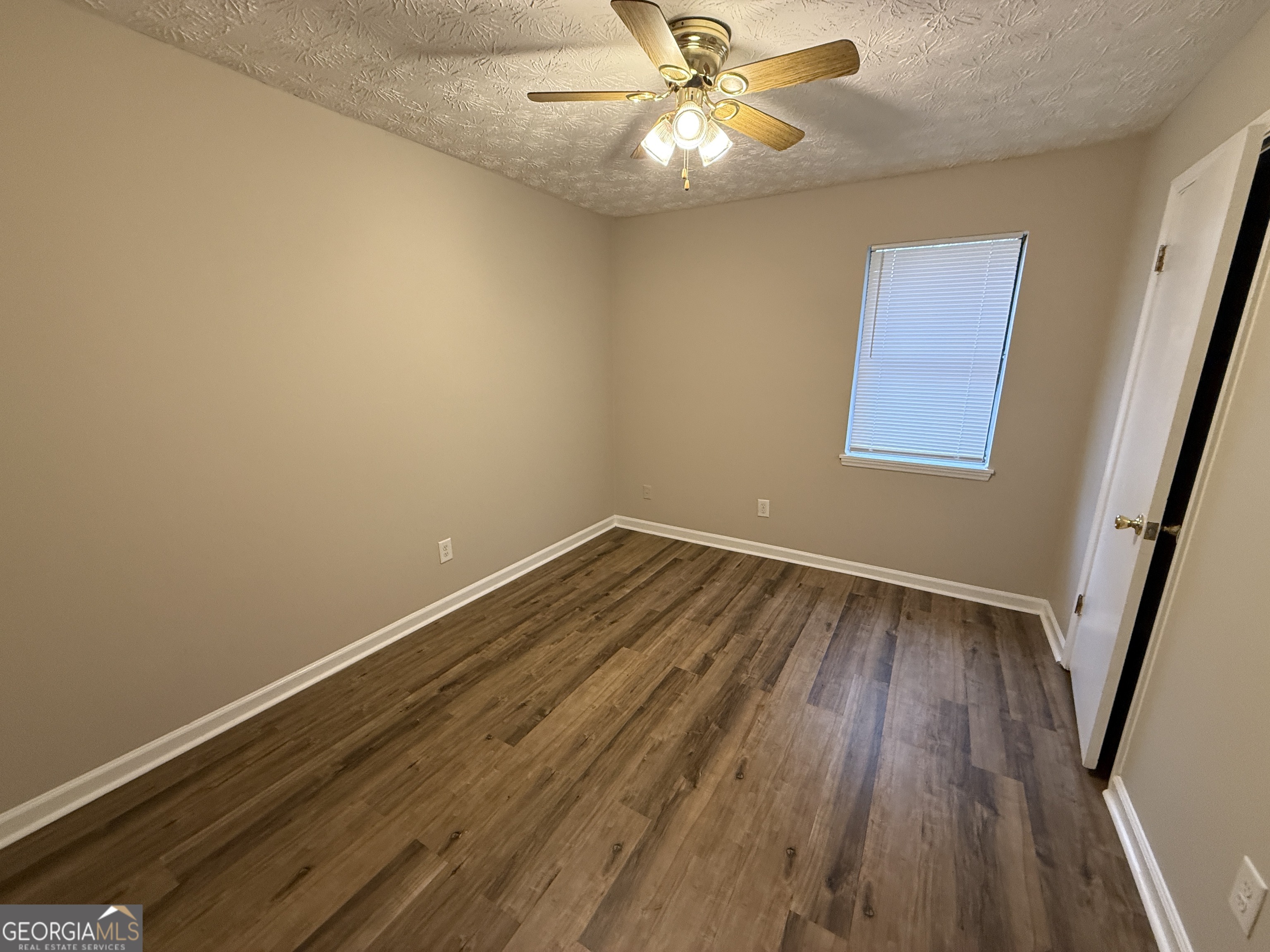 110 St Andrews Court, Unit 110 Athens, GA 30605 - Photo 7 of 13 wooden floor in an empty room with a window