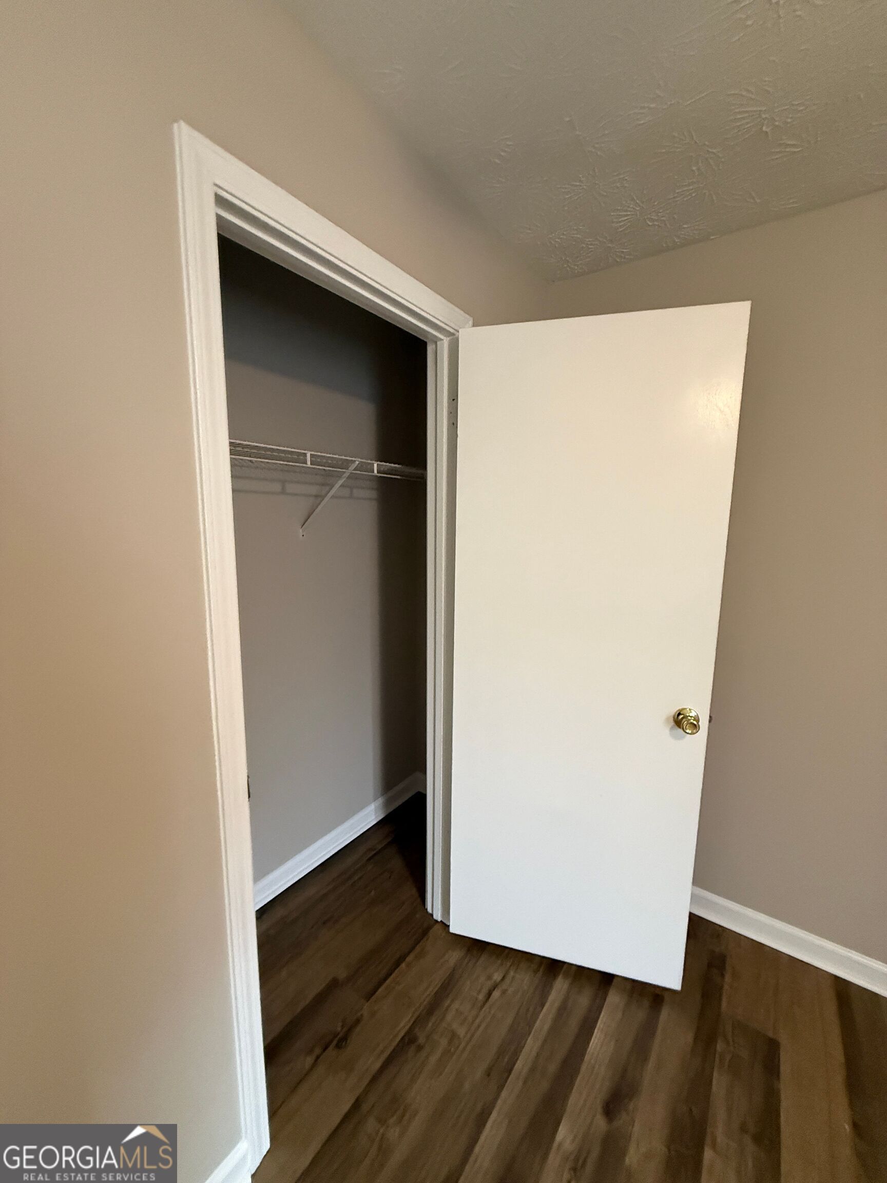 110 St Andrews Court, Unit 110 Athens, GA 30605 - Photo 8 of 13 a view of walk in closet with wooden floor