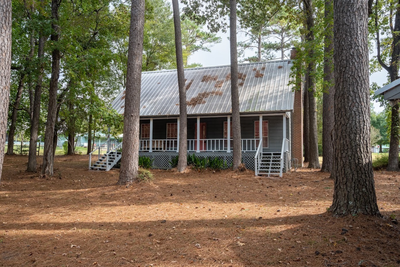 565 Timber Bay Drive Trinity, TX 75862 - Photo 3 of 49 a front view of a house with a garden and trees