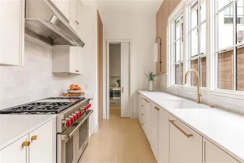 a kitchen with granite countertop a stove and a sink