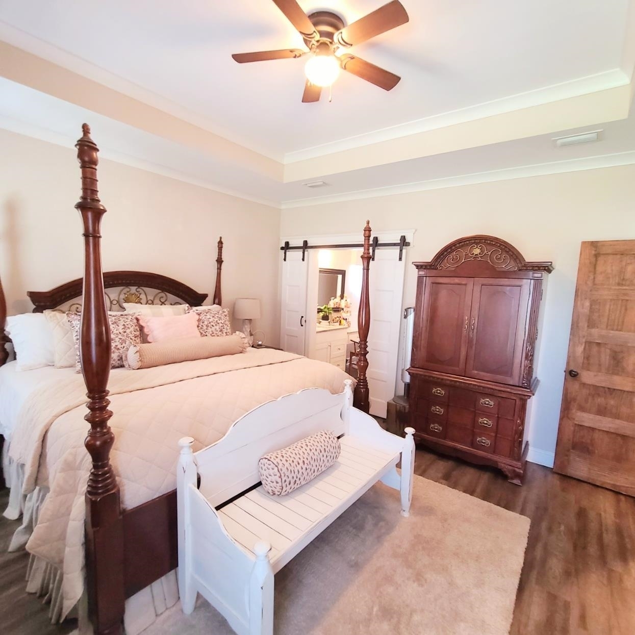 10051 Blackwell Nursery Road Semmes, AL 36575 - Photo 31 of 54 Bedroom with dark wood-style floors, ornamental molding, ceiling fan, connected bathroom, and a barn door