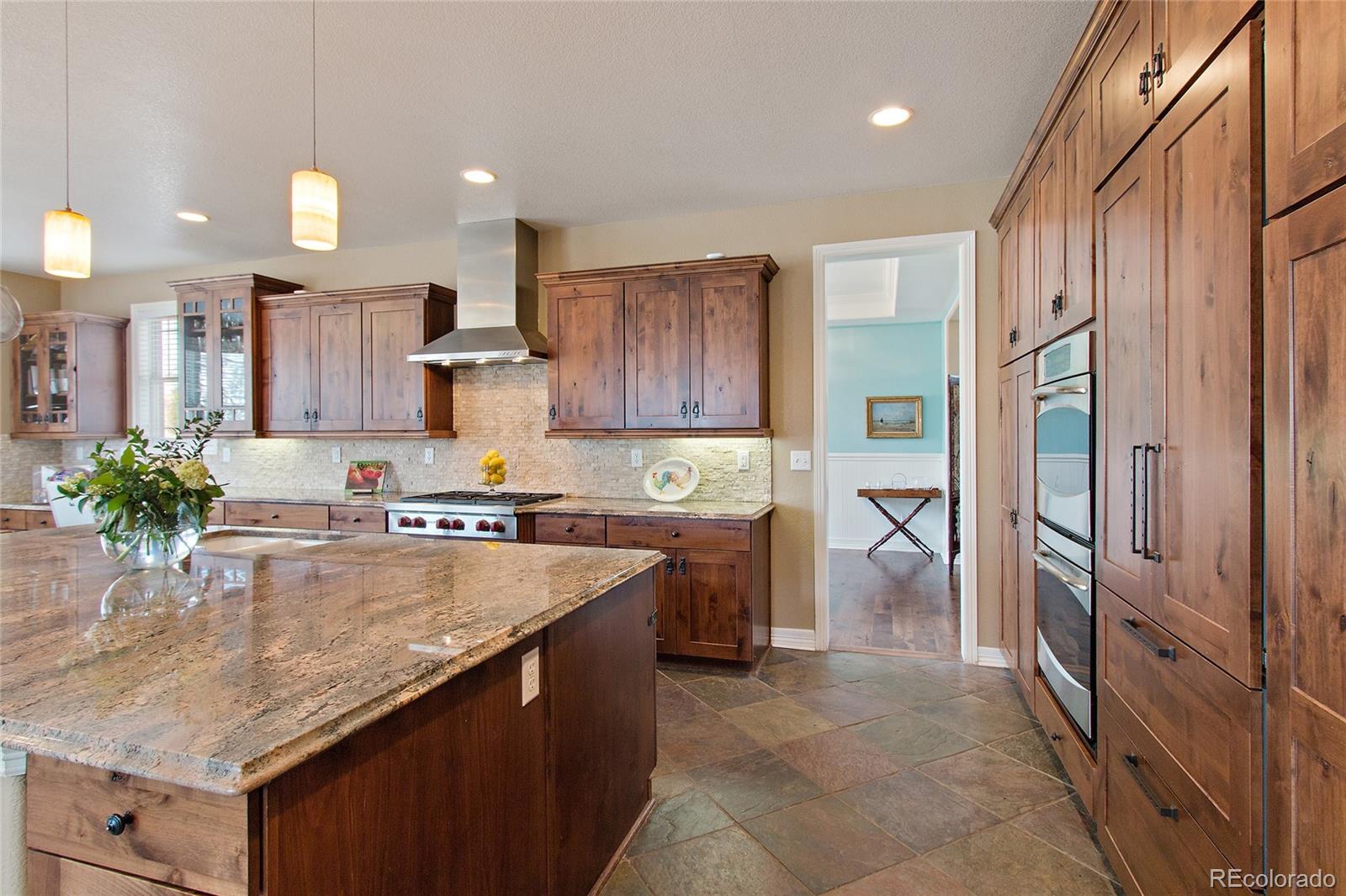 791 Elk Rest Road Evergreen, CO 80439 - Photo 13 of 35 a kitchen with stainless steel appliances granite countertop a refrigerator a sink and a stove