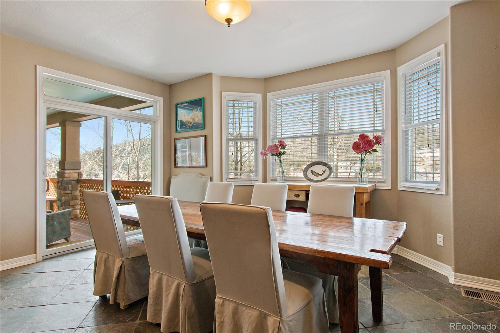 791 Elk Rest Road Evergreen, CO 80439 - Photo 16 of 35 a view of a dining room with furniture and window