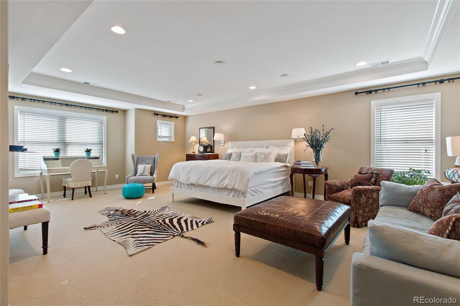 791 Elk Rest Road Evergreen, CO 80439 - Photo 20 of 35 a bedroom with furniture and a large window