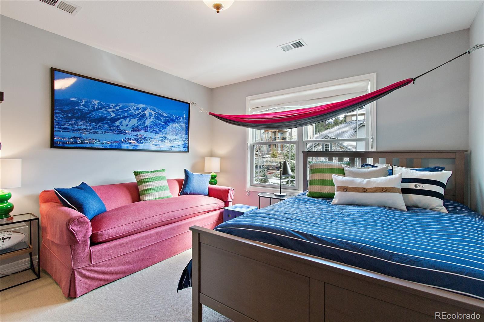 791 Elk Rest Road Evergreen, CO 80439 - Photo 22 of 35 a view of a dining room with furniture a chandelier and wooden floor