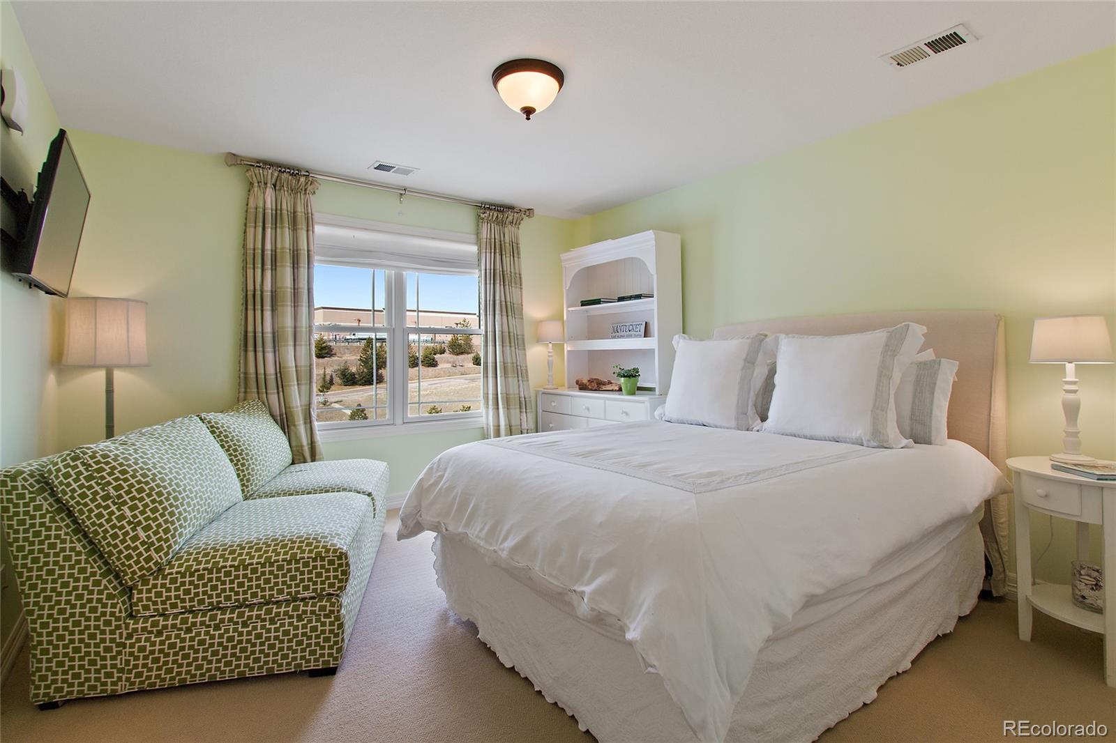 791 Elk Rest Road Evergreen, CO 80439 - Photo 24 of 35 a bedroom with a bed couch and window