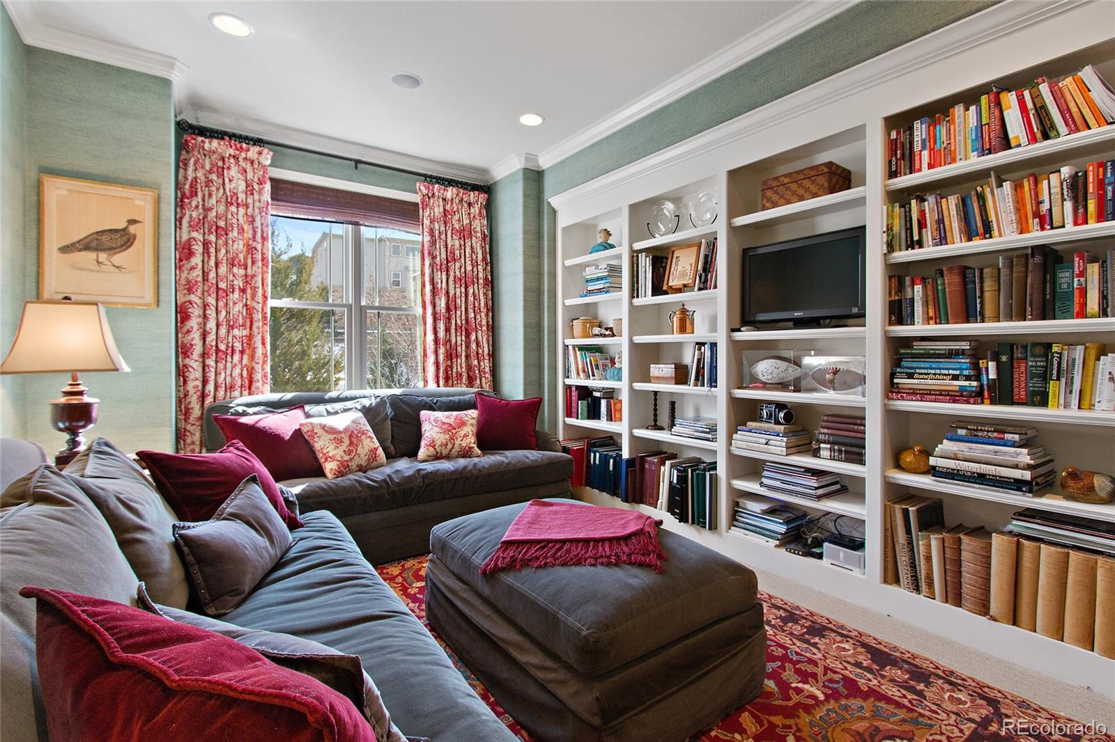 791 Elk Rest Road Evergreen, CO 80439 - Photo 4 of 35 a living room with furniture and a book shelf