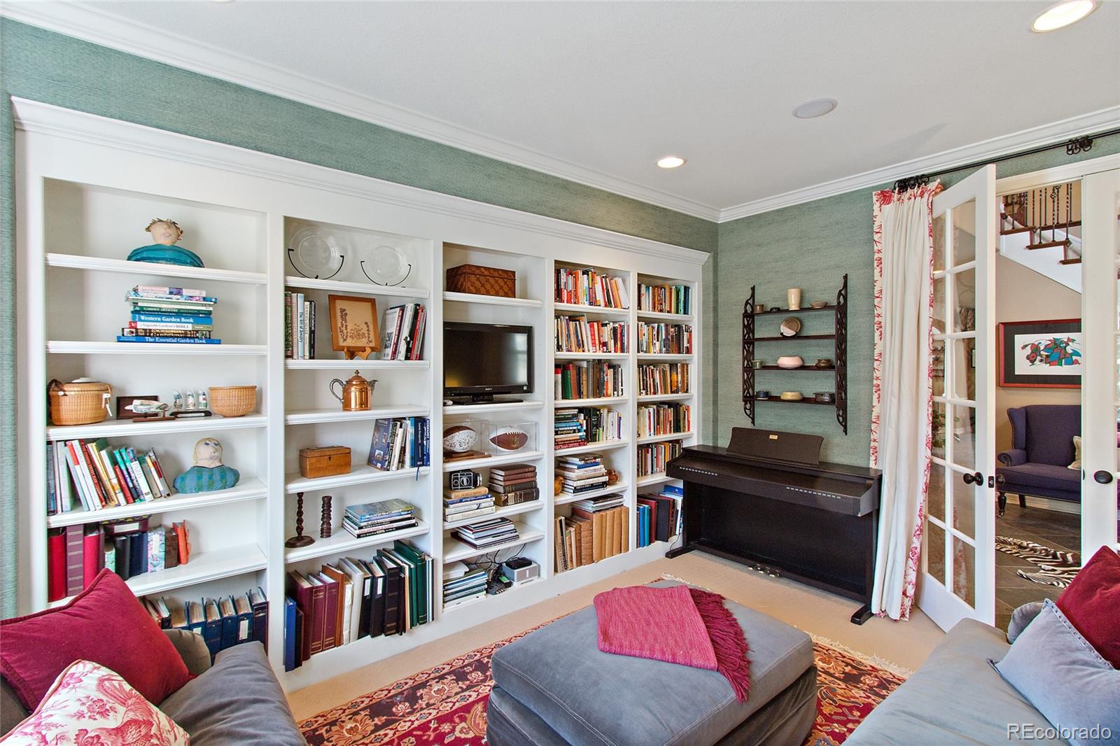 791 Elk Rest Road Evergreen, CO 80439 - Photo 5 of 35 a living room with furniture and a book shelf