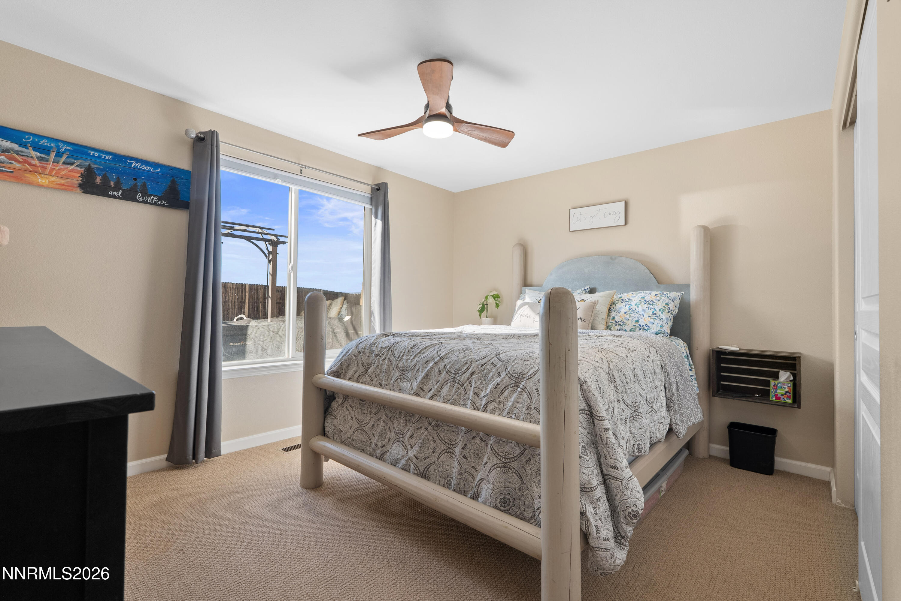 552 Spur Court Fernley, NV 89408 - Photo 35 of 46 a bed room with a bed and a ceiling fan