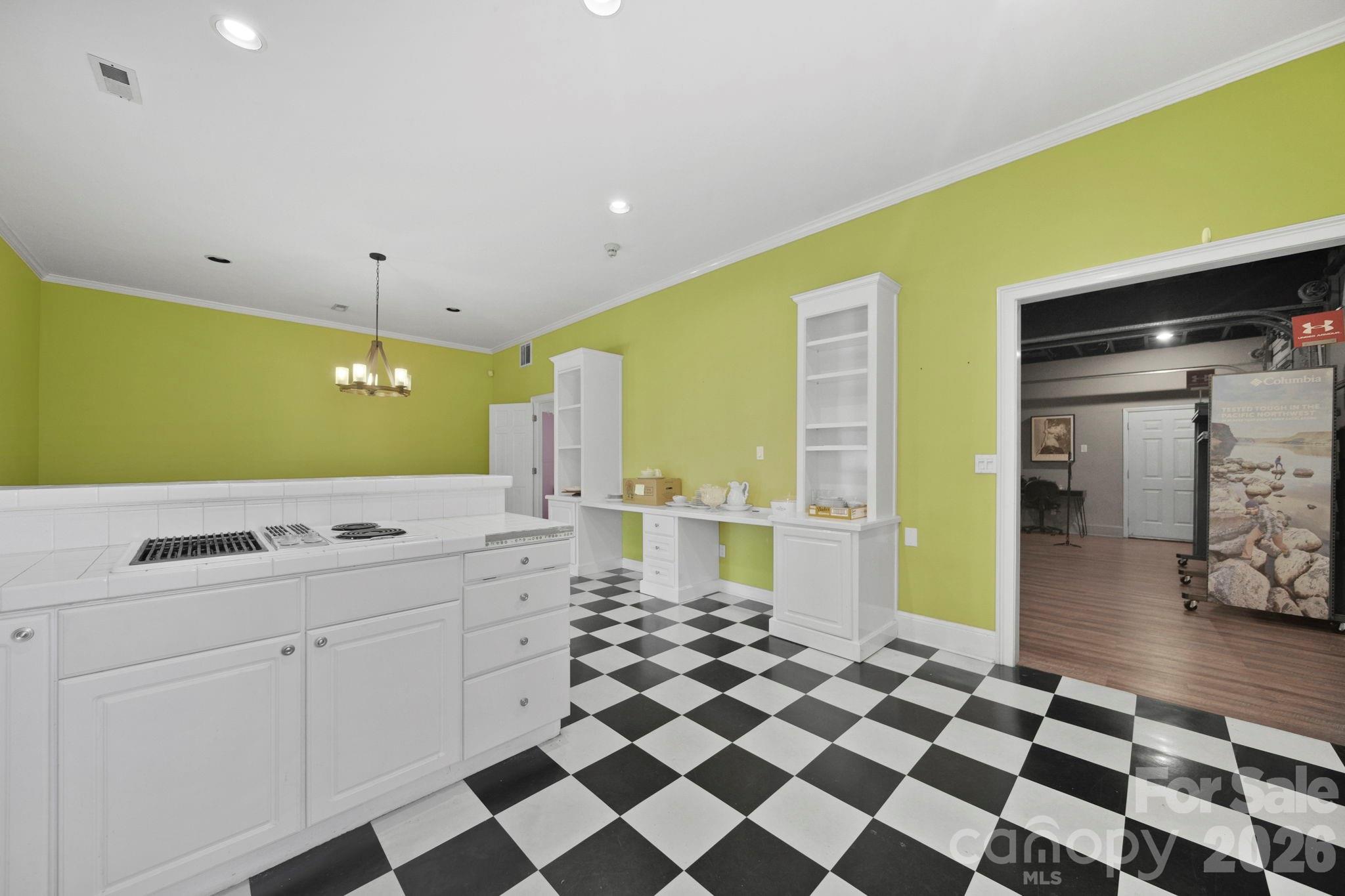 1109 Union Road Gastonia, NC 28054 - Photo 27 of 44 a kitchen with a checkered floor and white cabinets