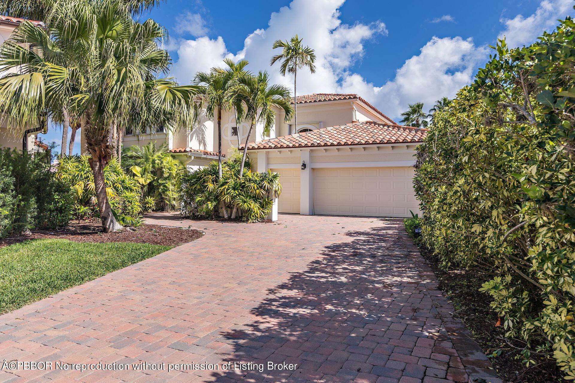 a front view of a house with a yard and a garage