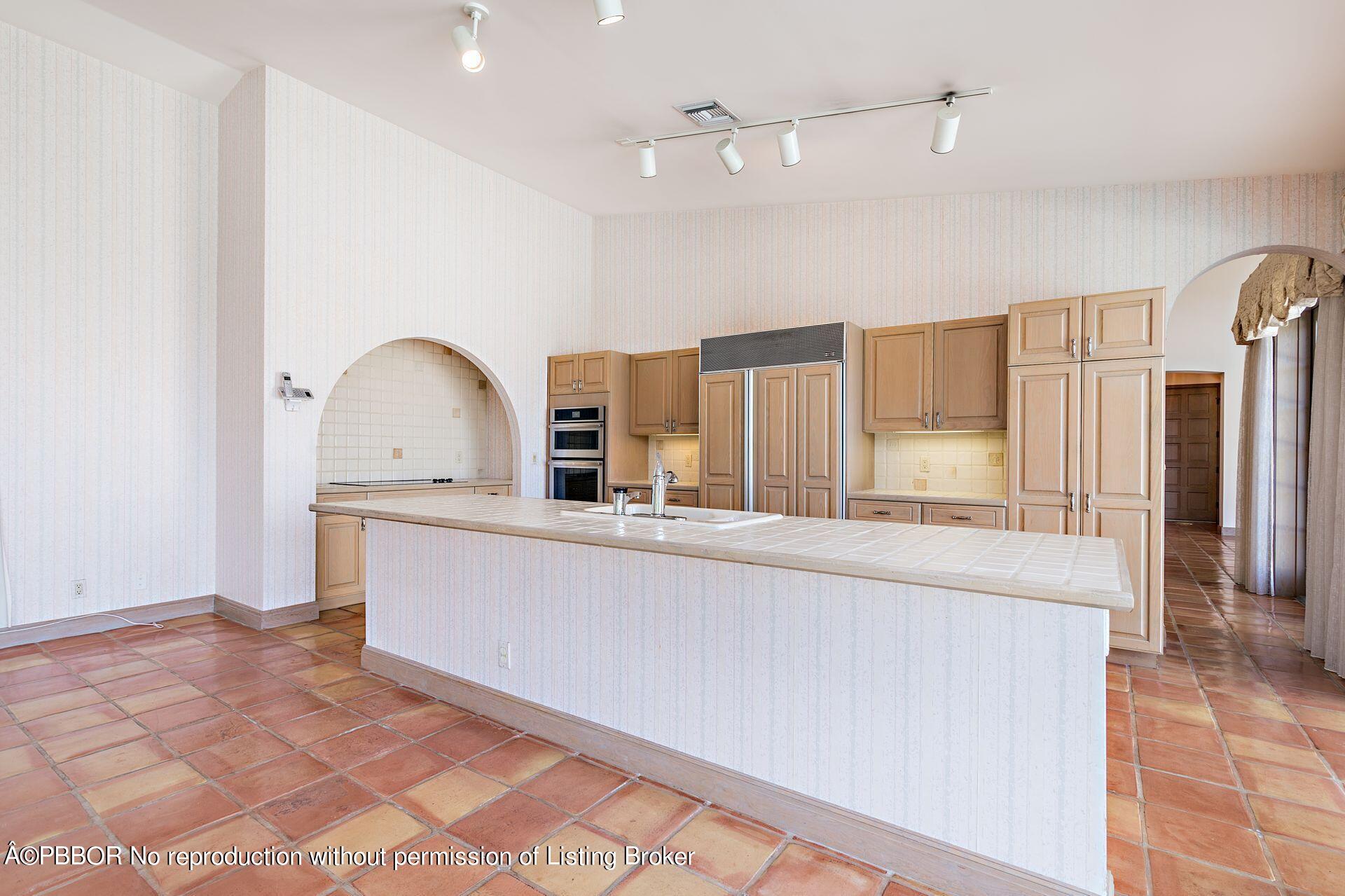 3299 Bridgegate Drive Jupiter, FL 33477 - Photo 11 of 48 a living room with stainless steel appliances kitchen island granite countertop a refrigerator a stove and a sink