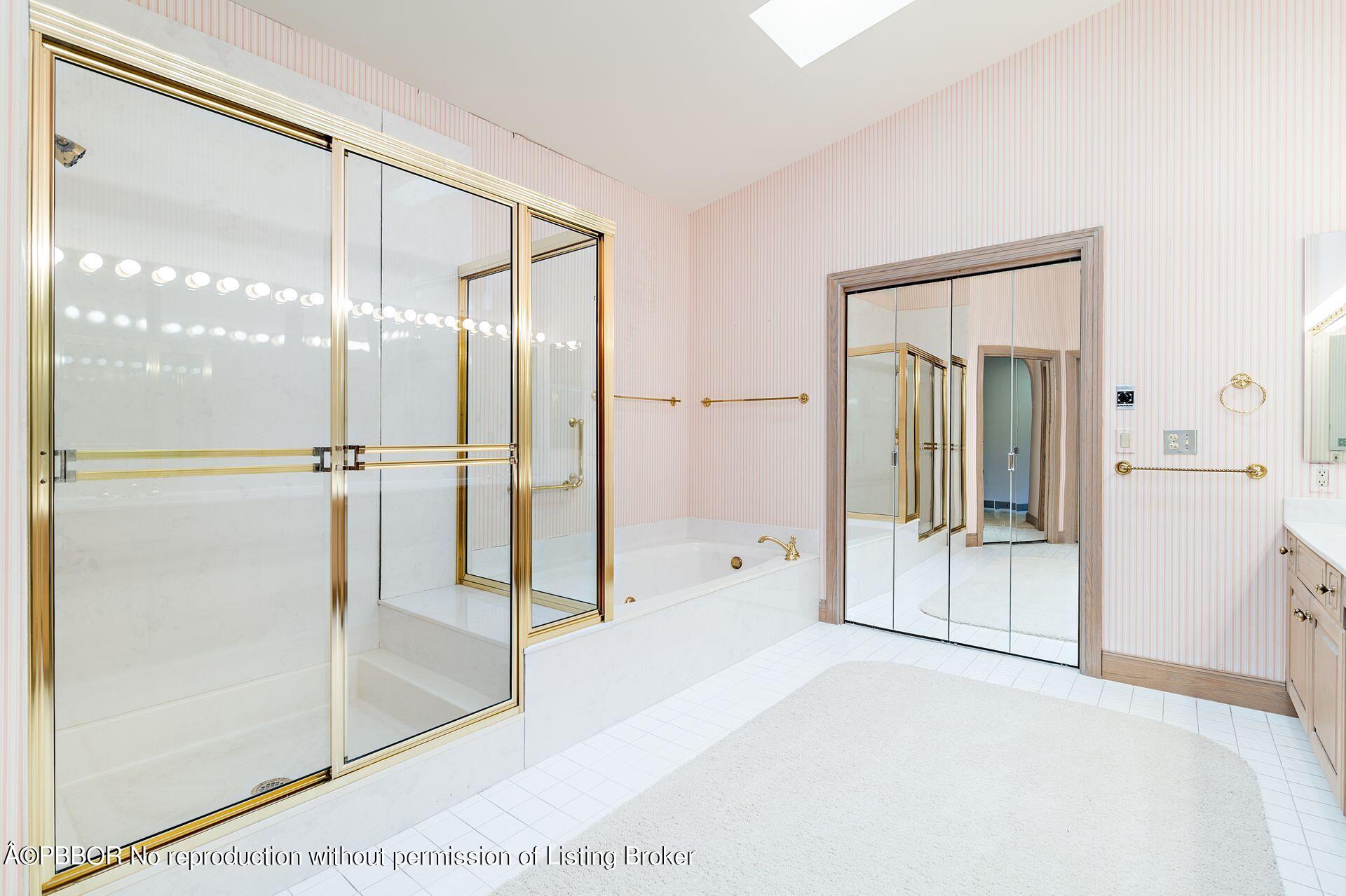 3299 Bridgegate Drive Jupiter, FL 33477 - Photo 19 of 48 a bathroom with a glass shower door