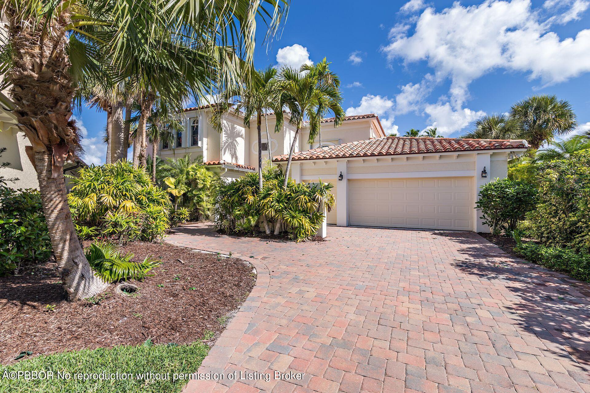 3299 Bridgegate Drive Jupiter, FL 33477 - Photo 2 of 48 a white house with a yard and plants