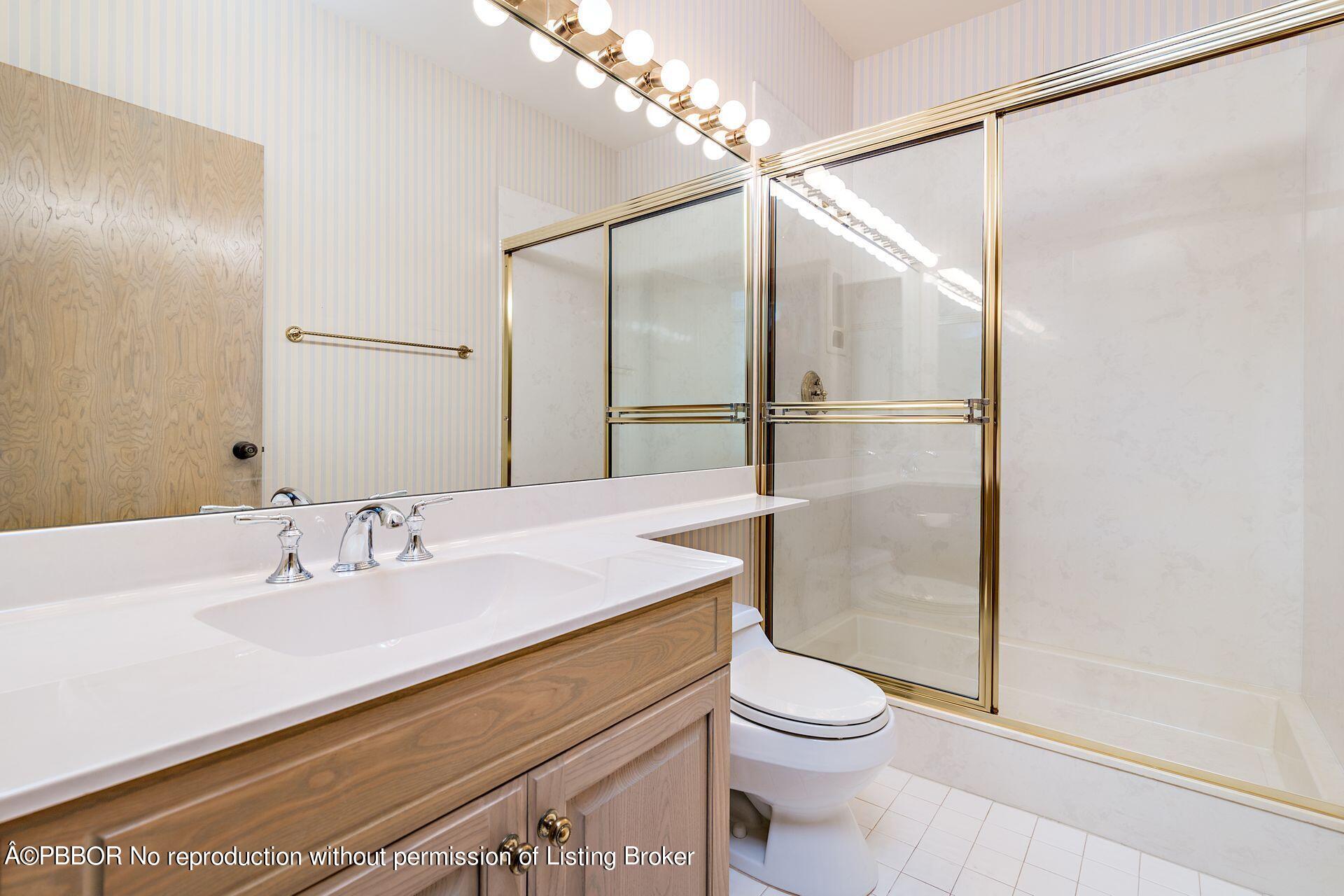 3299 Bridgegate Drive Jupiter, FL 33477 - Photo 23 of 48 a bathroom with a sink a toilet and shower