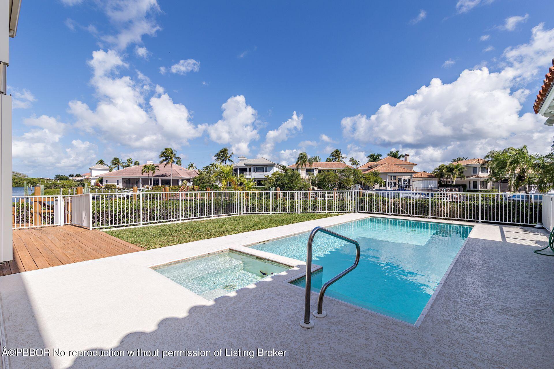 3299 Bridgegate Drive Jupiter, FL 33477 - Photo 30 of 48 a swimming pool with outdoor seating and yard