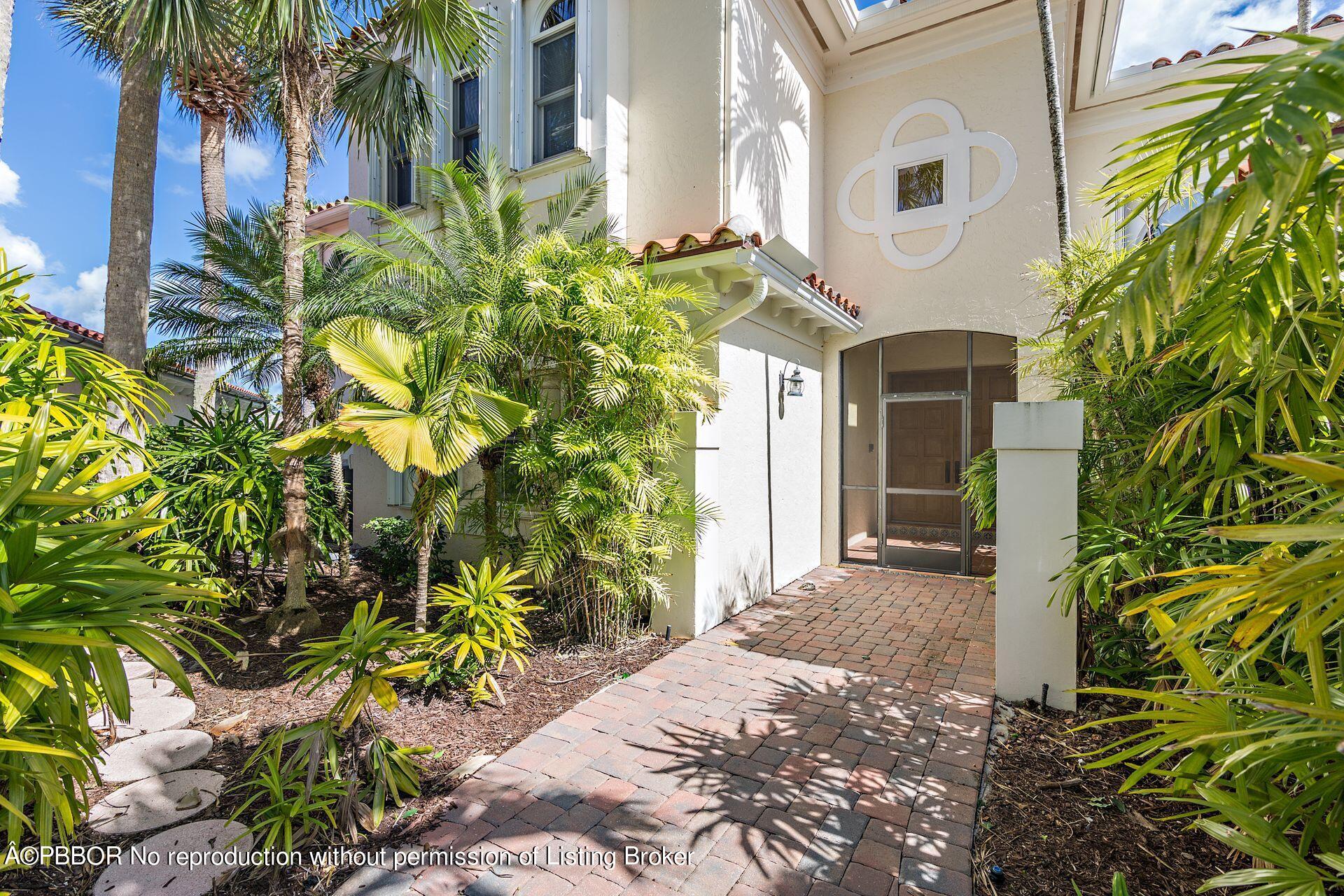 3299 Bridgegate Drive Jupiter, FL 33477 - Photo 4 of 48 a front view of a house with a yard