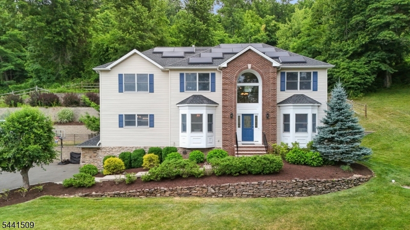 610 River Road Chatham, NJ 07928 - Photo 1 of 42 a front view of a house with a garden