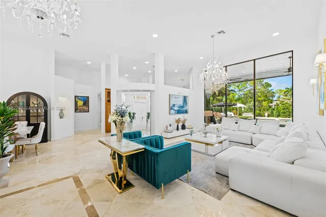 a living room with furniture potted plant and a large window
