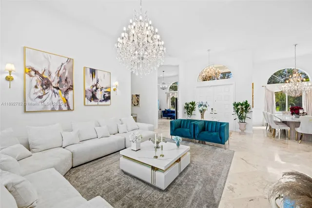 a living room with furniture a chandelier and a couch