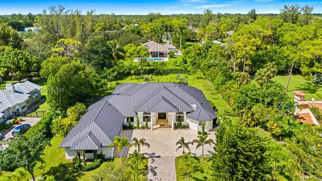 an aerial view of a house with a yard