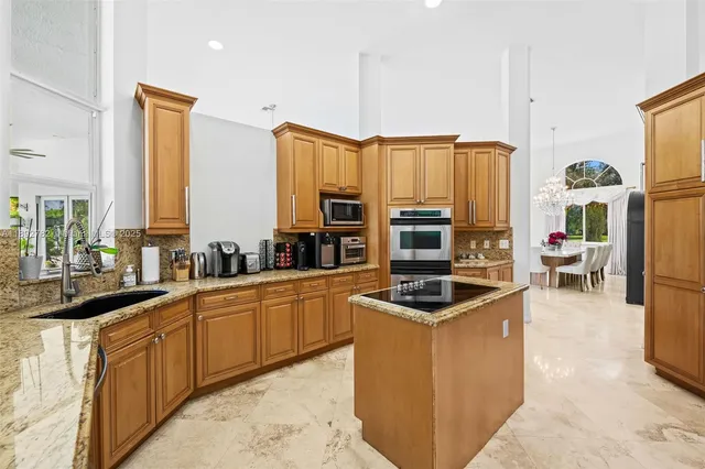 a kitchen with a refrigerator sink and cabinets