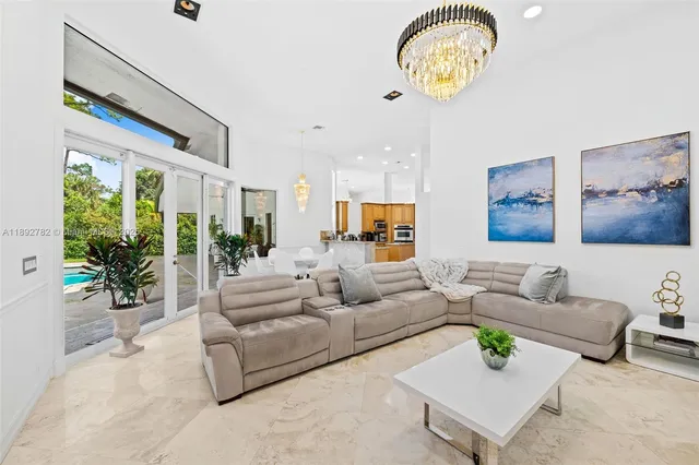 a living room with furniture and a chandelier