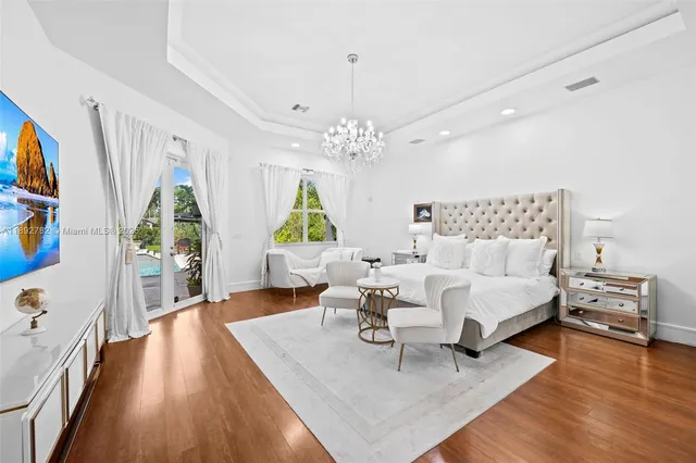 a bedroom with furniture and a flat screen tv