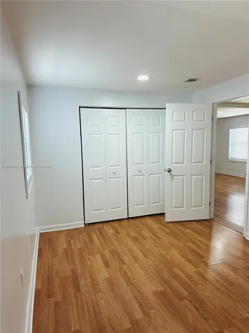 a view of room with wooden floor