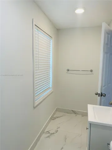 a bathroom with a double vanity sink toilet mirror and bathtub