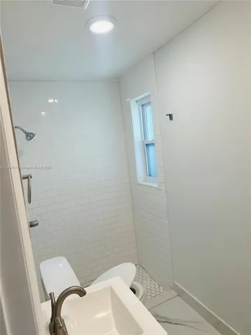 a sink with white cabinets