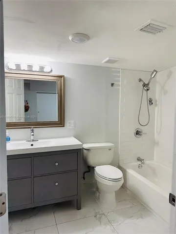 a bathroom with a sink vanity and mirror