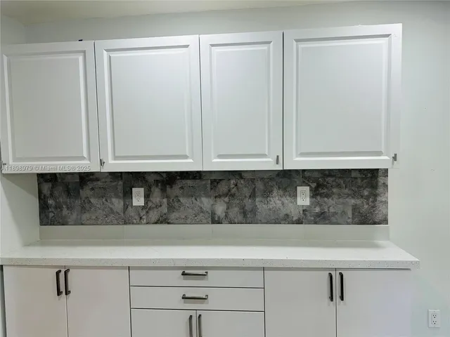 a kitchen with a refrigerator sink and microwave