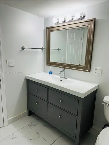 a kitchen with cabinets and stainless steel appliances