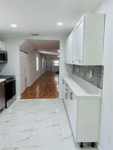 a view of a refrigerator and window in a kitchen