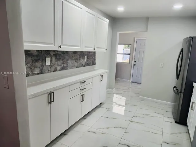 a view of a hallway with washer and dryer