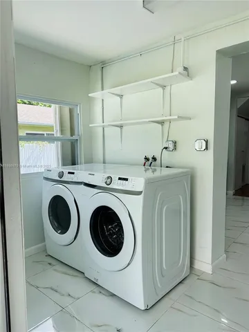 a view of storage and utility room with washer and dryer