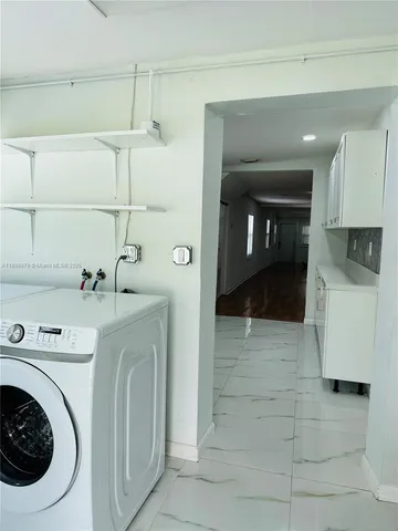 a white kitchen with a stove and white cabinets