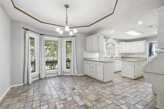 a kitchen with a stove a sink dishwasher a refrigerator and a oven