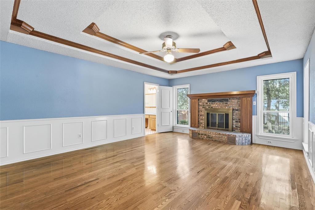 6140 Dick Price Road Fort Worth, TX 76140 - Photo 15 of 40 a view of an empty room with wooden floor and a window