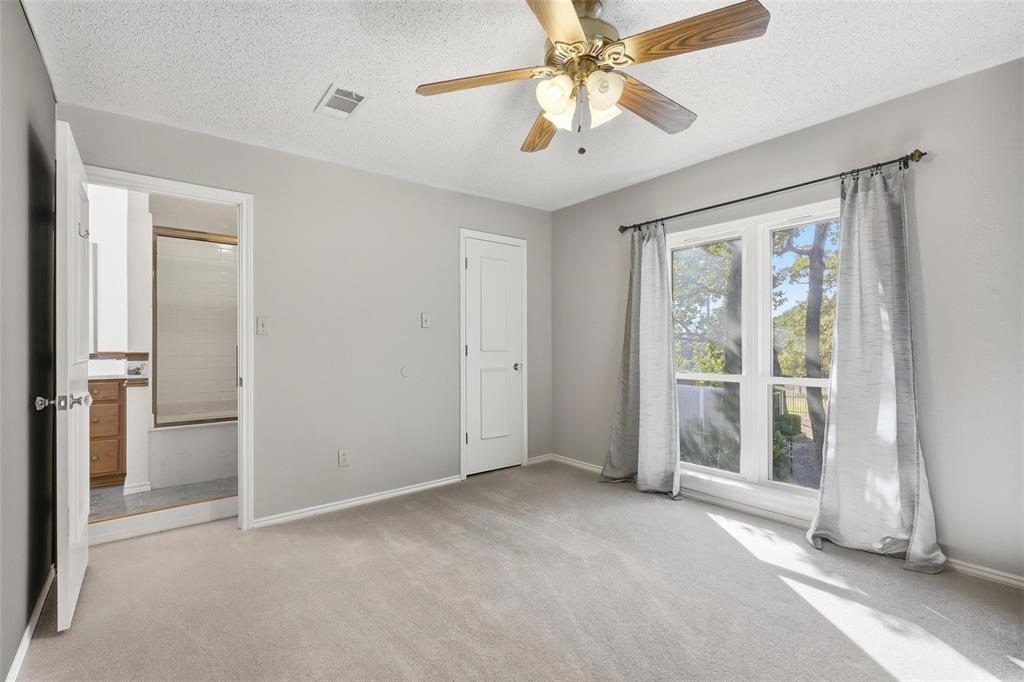 6140 Dick Price Road Fort Worth, TX 76140 - Photo 17 of 40 an empty room with chandelier fan and windows