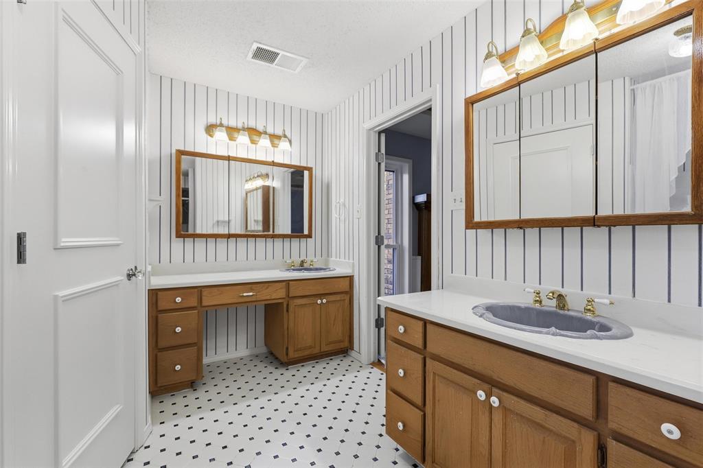 6140 Dick Price Road Fort Worth, TX 76140 - Photo 18 of 40 a bathroom with a granite countertop sink a mirror and a