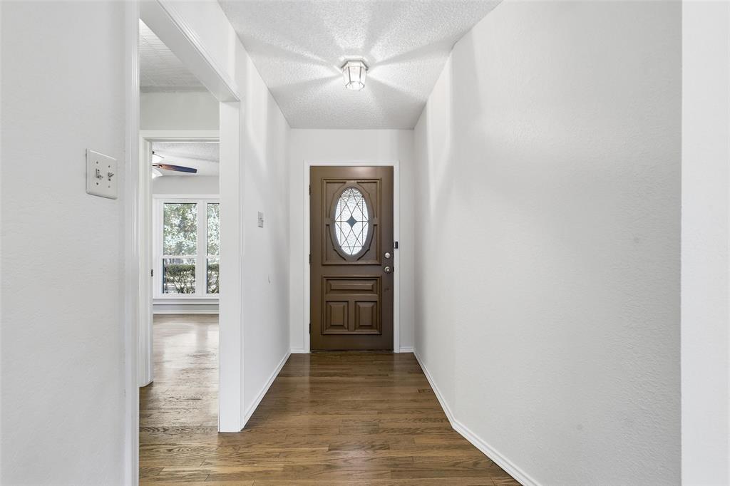 6140 Dick Price Road Fort Worth, TX 76140 - Photo 6 of 40 a view of a hallway view with wooden floor and a bathroom